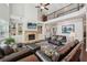 Spacious living room with stone fireplace, built-in bookshelves, and soaring ceilings at 2315 Saddle Brook Trce, Cumming, GA 30040
