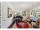 Elegant living room with a piano, decorative rug, and large windows providing plenty of natural light at 2315 Saddle Brook Trce, Cumming, GA 30040