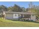 Exterior shot of a home with a screened porch, steps to the yard, and a well-maintained lawn at 2376 Falls River Dr, Lithia Springs, GA 30122