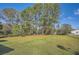 Lush backyard with a well-manicured lawn, mature trees, and a trampoline visible at 2376 Falls River Dr, Lithia Springs, GA 30122