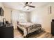 Bedroom featuring a bed with a patterned coverlet, a ceiling fan, and stylish wood-look floors at 2376 Falls River Dr, Lithia Springs, GA 30122