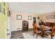An open dining room area with hard surface floors, vintage furniture, and a charming, neutral color palette at 2376 Falls River Dr, Lithia Springs, GA 30122