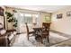 A dining room featuring a wood table with seating for four, modern flooring, and ample natural light at 2376 Falls River Dr, Lithia Springs, GA 30122
