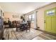 Dining room view showcases natural light, hard surface floors, and a vibrant lime green door at 2376 Falls River Dr, Lithia Springs, GA 30122