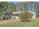 An inviting exterior featuring a light grey brick facade, a lime green front door, and a well-maintained lawn at 2376 Falls River Dr, Lithia Springs, GA 30122