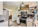 Functional kitchen layout featuring stainless steel appliances, ample counter space, and a view into the adjacent dining area at 2376 Falls River Dr, Lithia Springs, GA 30122