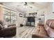 A modern living room featuring comfortable leather seating, gray toned flooring, and sliding glass door access to the outside at 2376 Falls River Dr, Lithia Springs, GA 30122