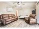 Inviting living room with leather seating, sliding glass doors, modern flooring, and a ceiling fan at 2376 Falls River Dr, Lithia Springs, GA 30122