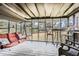 Relaxing screened-in porch with comfortable seating, a table, and views of the backyard at 2376 Falls River Dr, Lithia Springs, GA 30122