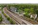 Overhead view of modern townhomes near train tracks and green spaces with the city skyline in the distance at 286 Norwood Ne Ave, Atlanta, GA 30317
