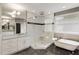 Luxurious bathroom featuring a glass enclosed shower, soaking tub, and marble countertops at 286 Norwood Ne Ave, Atlanta, GA 30317