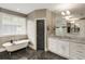 Spa-like bathroom featuring a soaking tub, marble countertops, and natural light at 286 Norwood Ne Ave, Atlanta, GA 30317