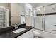 Bathroom featuring a vanity with a gray countertop, a mirror, a shower with a sliding door and a toilet at 286 Norwood Ne Ave, Atlanta, GA 30317