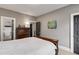 Bedroom featuring gray walls, white bedding, a colorful print, and dark doors at 286 Norwood Ne Ave, Atlanta, GA 30317