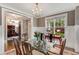 Beautiful dining room with natural light, stylish furnishings and a glimpse into a lovely home office at 286 Norwood Ne Ave, Atlanta, GA 30317