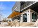 Striking two-story brewery features black metal siding, stylish black-framed windows, and inviting outdoor seating at 286 Norwood Ne Ave, Atlanta, GA 30317