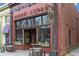 Rustic brick store with charming barrel tables and stools, a welcoming entrance, and vintage-inspired signage at 286 Norwood Ne Ave, Atlanta, GA 30317