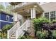 Inviting covered front porch with brick accents and manicured landscaping, creating a welcoming entryway at 286 Norwood Ne Ave, Atlanta, GA 30317