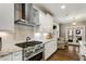 Modern kitchen with stainless appliances, granite countertops, a stylish backsplash, and backyard views at 286 Norwood Ne Ave, Atlanta, GA 30317