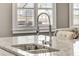 Kitchen island sink featuring granite countertops and a stainless steel faucet at 286 Norwood Ne Ave, Atlanta, GA 30317