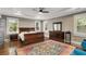 Spacious main bedroom featuring tray ceilings, natural light, and hardwood floors at 286 Norwood Ne Ave, Atlanta, GA 30317