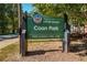 Sign for Coan Park in the city of Atlanta with park hours listed at 286 Norwood Ne Ave, Atlanta, GA 30317