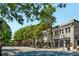 Historic downtown streetscape with shops, mature trees, and pedestrian crossing at 286 Norwood Ne Ave, Atlanta, GA 30317