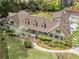 Aerial view of a single-Gathering home featuring lush landscaping, a putting green, and a driveway at 299 Saint Marys Nw Ln, Marietta, GA 30064