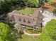 Expansive aerial view showcases the well-manicured lawn, mature trees, and elegant architecture of this luxurious estate home at 299 Saint Marys Nw Ln, Marietta, GA 30064