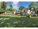 Sprawling backyard featuring a manicured lawn and lush, mature landscaping at 299 Saint Marys Nw Ln, Marietta, GA 30064
