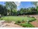Landscaped backyard featuring a green lawn and decorative stone features at 299 Saint Marys Nw Ln, Marietta, GA 30064
