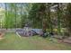 Backyard play area with a swing set, lawnmower, and garden boxes at 299 Saint Marys Nw Ln, Marietta, GA 30064