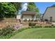 Landscaped backyard showing a storage building and a retaining wall with flowers at 299 Saint Marys Nw Ln, Marietta, GA 30064
