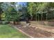 Private backyard featuring an elevated garden area and mature trees at 299 Saint Marys Nw Ln, Marietta, GA 30064