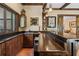 This wet bar has rustic wood finishes, a sink, beer tap, and plenty of counter space at 299 Saint Marys Nw Ln, Marietta, GA 30064