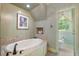 Neutral bathroom featuring garden tub, toilet room and picture window at 299 Saint Marys Nw Ln, Marietta, GA 30064