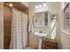 Bathroom with walk-in shower, pedestal sink, vanity mirror, and natural light at 299 Saint Marys Nw Ln, Marietta, GA 30064