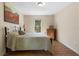 Bedroom with wood floors, a full bed, and a window to the backyard at 299 Saint Marys Nw Ln, Marietta, GA 30064