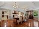 Bright dining room featuring a stone fireplace, hardwood floors, and coffered ceilings at 299 Saint Marys Nw Ln, Marietta, GA 30064