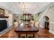 Formal dining area with hardwood floors, stone fireplace, and backyard views at 299 Saint Marys Nw Ln, Marietta, GA 30064
