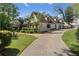 Beautifully landscaped exterior featuring a well-maintained lawn, mature trees, and an inviting driveway leading to the garage at 299 Saint Marys Nw Ln, Marietta, GA 30064