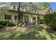 Charming front exterior with a covered porch, manicured landscaping, and a welcoming entryway with flowering trees in view at 299 Saint Marys Nw Ln, Marietta, GA 30064