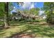 Expansive front lawn showcasing the home's exterior, mature trees, and verdant landscaping, creating a serene and inviting atmosphere at 299 Saint Marys Nw Ln, Marietta, GA 30064