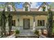 Inviting front porch with brick accents, classic columns, and a well-manicured landscape at 299 Saint Marys Nw Ln, Marietta, GA 30064