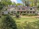 Charming single-Gathering home boasts a manicured lawn, blooming trees and a brick facade at 299 Saint Marys Nw Ln, Marietta, GA 30064