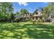 Lush front yard view showcasing the home's facade, mature trees, and pristine lawn, creating a welcoming and picturesque scene at 299 Saint Marys Nw Ln, Marietta, GA 30064
