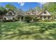 Well-manicured front yard with lush green grass, flowering trees, and tasteful landscaping enhancing the home's curb appeal at 299 Saint Marys Nw Ln, Marietta, GA 30064