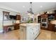 Gourmet kitchen featuring a large center island, custom cabinetry, granite countertops, and tile flooring at 299 Saint Marys Nw Ln, Marietta, GA 30064