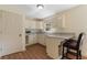 Kitchenette features white cabinets, granite countertops, and a breakfast bar at 299 Saint Marys Nw Ln, Marietta, GA 30064