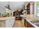 Spacious kitchen features an island, granite counters, tile floors, and stainless steel appliances at 299 Saint Marys Nw Ln, Marietta, GA 30064
